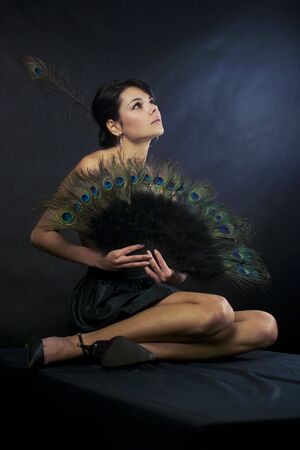 sexy girl in a dress with peacock feathersの写真素材