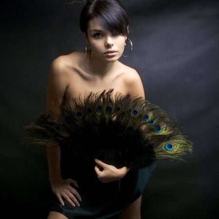 sexy girl in a dress with peacock feathersの写真素材