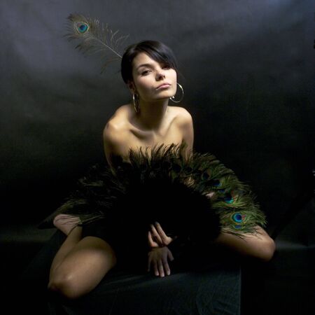 sexy girl in a dress with peacock feathersの写真素材
