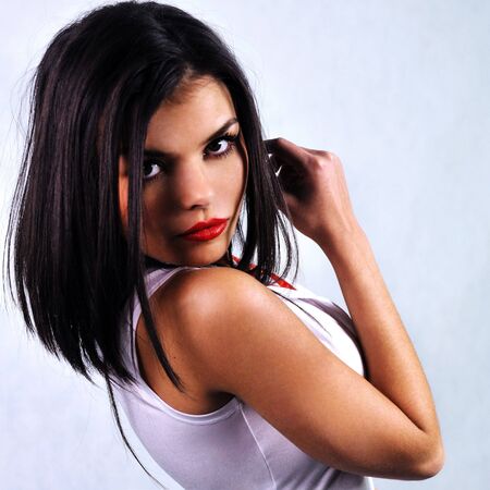 portrait of a woman with red lips in a white dressの写真素材