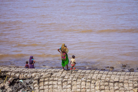 Mother and child looking at the sea. udwada beach valsad.の写真素材