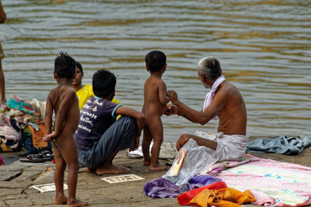 Indian Family bathing outdoor near river at Sangli State Maharashtra Indiaのeditorial素材