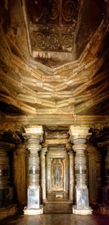 Garbhagriha ("sanctum") and large granite pillars with the inner sanctum and statue of Tirthankara (ford-makers or propagators of dharma) of Jainism. Halebidu District Hassan State Karnataka Indiaのeditorial素材