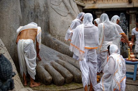 Male worshiper praying at Gommateshwara statue located on Vindyagiri at Shravanbelagola in the...