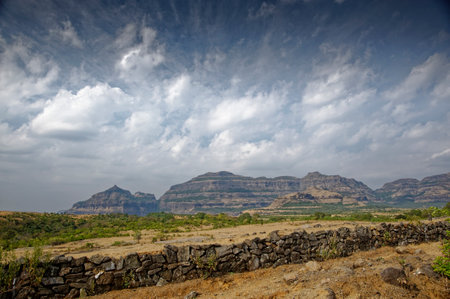Lofty rugged hills of the Western Ghats at Maleshj Ghat District Pune State Maharashtra India 01/26/2015の写真素材