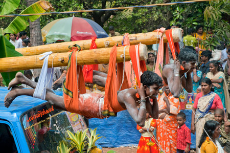 Devotees fulfilling vow by hanging with hooks in Thaipusam Festival in Kerala India 01 30 2010のeditorial素材