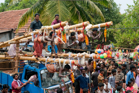 Devotees fulfilling vow by hanging with hooks in Thaipusam Festival in Kerala India 01 30 2010のeditorial素材