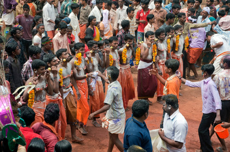 Group of men piercing spikes through cheeks discharging vow in Thaipusam Festival in state Kerala...