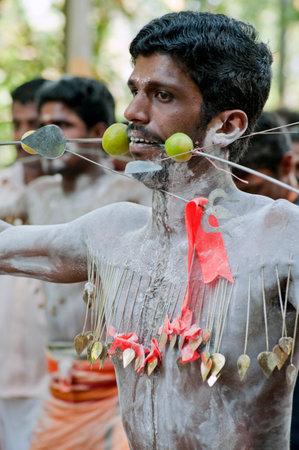 Man piercing spikes through cheeks discharging vow in Thaipusam Festival in state Kerala India 01 30 2010のeditorial素材