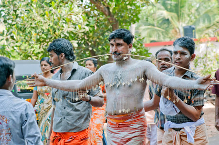 Man piercing spikes through cheeks discharging vow in Thaipusam Festival in state Kerala India 01 30 2010のeditorial素材