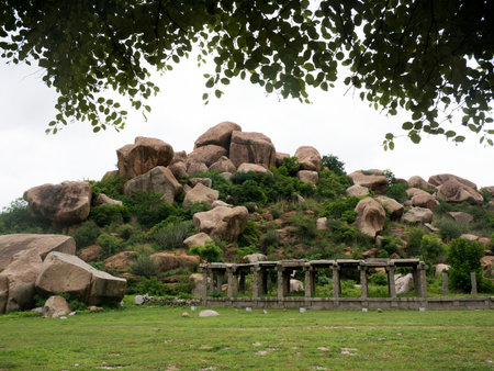 Ruins of temples in front of rocky hill at Hampi state karnataka India 08 06 2022の写真素材