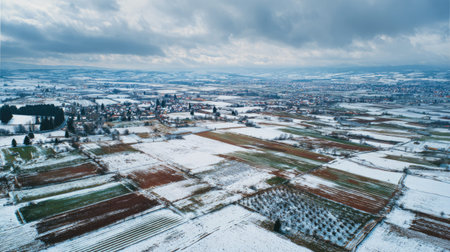 A photograph of Central European countryside with patchwork agricultural fields, orchard fruit...