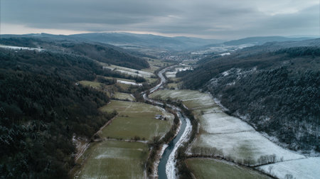 A photograph of Central European countryside with rural valley with winding stream, countryside...