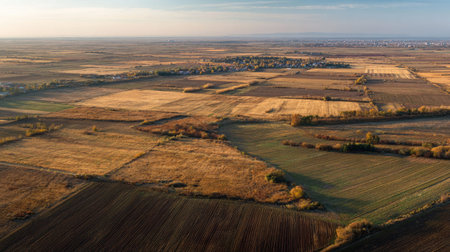 A photograph of Eastern European plains 85 with open plains with farm fields, dry grass patches,...