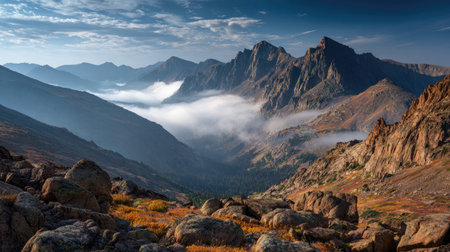 A photograph of Rocky Mountains wilderness 47 with rocky mountain peaks above clouds, rocky alpine...