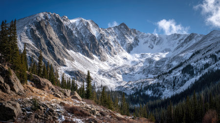 A photograph of Rocky Mountains wilderness with towering rocky mountain peaks, rocky alpine terrain,...