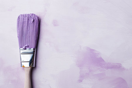 Paint brush dipped in purple paint on light background, copy space. Home repair and finishing. AI generated.の素材