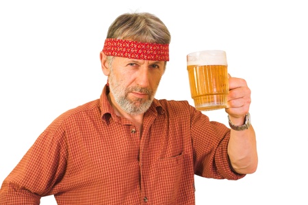 Horizontal portrait of a matured, graying, unshaved guy wearing a red shirt, with a mug of beer in a hand. の写真素材