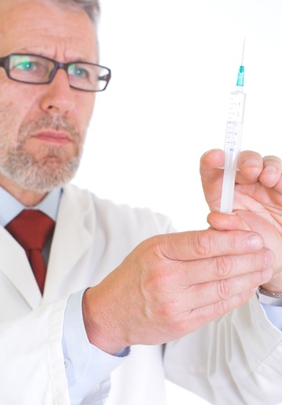 Image presents a doctor in white coat, getting ready for vaccination â he holds a syringe full of vaccine  Background white  の写真素材