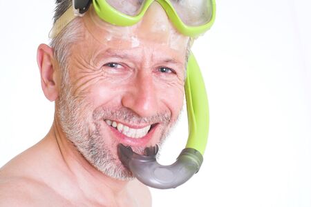 Portrait of a wet smiling man with a tube and mask for plunge  Background is white の写真素材