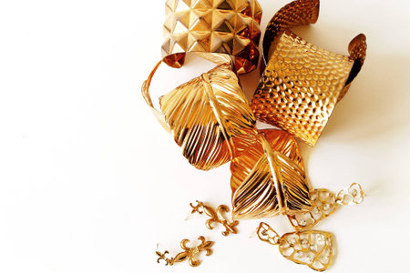 golden bracelet  and earring on white backgroundの写真素材