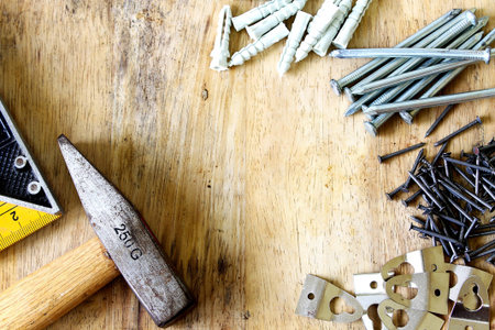 hammer and nail and cleat on wood background,technician tool