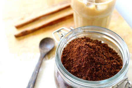 instant coffee in glass bowl and wood teaspoon and ice coffee on wood background,vacuum jar,cinnamon stickの写真素材