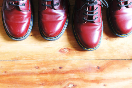 red cherry leather boot dark brown sting two pair on wooden background have copy spaceの写真素材
