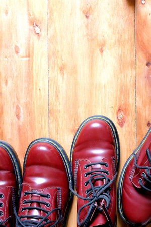 red cherry leather boot dark brown sting two pair on wooden background have copy spaceの写真素材