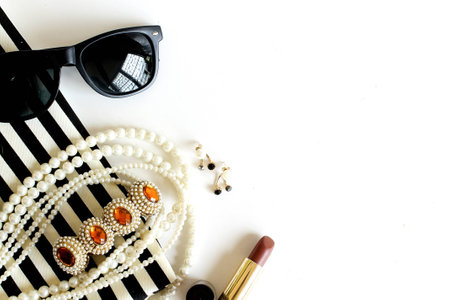 lipstick sunglass pearl necklace fabric on white backgroundの写真素材