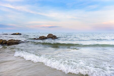 Sea wave and stone and the blue sky at "HUA HIN" beach Thailandの写真素材