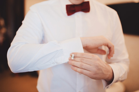 The groom adjusts his cuffs and clothes cufflinkの写真素材