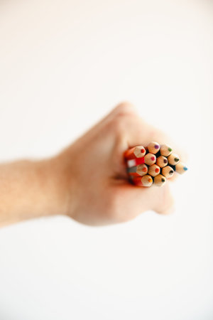 Man holding a fist in his hand Colorful two-color double-sided pencils, white background