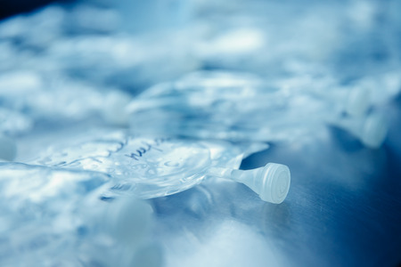 Dropper in a vein close-up. Blue background. The concept of body cleansingの写真素材