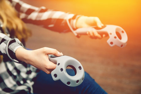 girl is holding a virtual reality joystick. The concept of the game in reality.high contrast and...