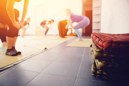 rug and a pillow for practicing yoga in the hall on the background of teamwork in meditation and stretching.の写真素材