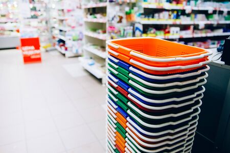 Stack of baskets in the supermarket. Shopping Basket Blue Interior Shop shelf. business backgroundの写真素材