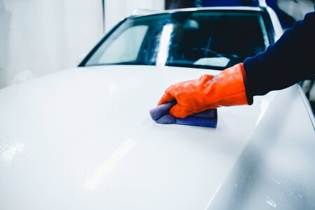 hands hold sponge for washing car. Concept manual car wash for cars.の写真素材