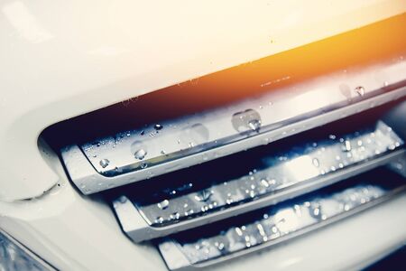 White car with drops of water after a car wash. .Concrete car cleaning.の写真素材