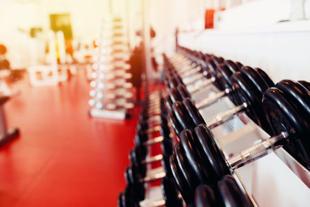 Sports equipment dumbbell rests in a row in gym