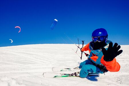 Skier with a kite on fresh snow in the winter in the tundra of Russia against a clear blue sky. Teriberka, Kola Peninsula, Russia. Concept of winter sports snowkite on ski.の写真素材