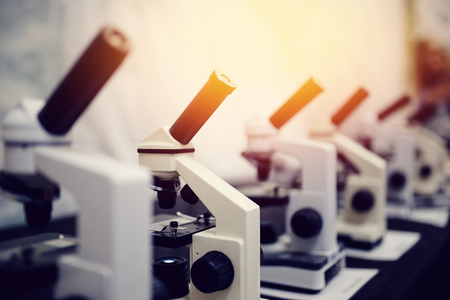 series of microscopes of monochrome color and with a glare. Concept of biology and research medical equipment.の写真素材