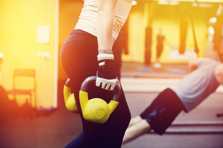Close-up girl is Training with a dumbbell in the gym.concept of fitnessの写真素材