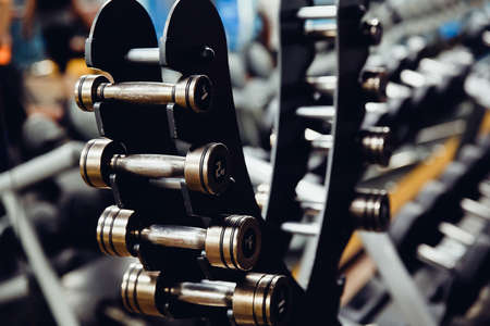 Sports equipment dumbbell rests in a row. high contrast and monochrome color tone.の写真素材
