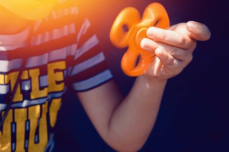 Child boy to play with Fidget Spinner in his hands, the concept of relieving stress, develop a small hand mathematics.の写真素材