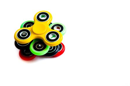 Fidget finger spinner, anxiety relief toy on white isolated background, copyspace. Concept relieving stressの写真素材