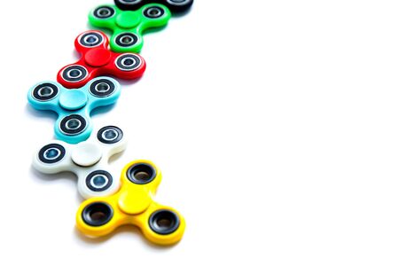 Fidget finger spinner, anxiety relief toy on white isolated background, copyspace. Concept relieving stressの写真素材