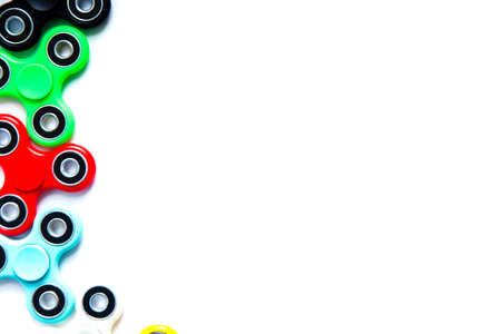 Fidget finger spinner, anxiety relief toy on white isolated background, copyspace. Concept relieving stressの写真素材