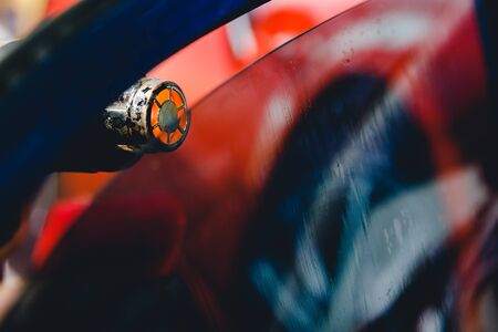 Master installs a tint film for the car glass with a hairdryer and spatula with glare of light. Concept tinting carの写真素材