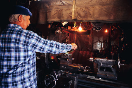 master man in years manages the milling machine, the concept of industrial photography, the 60th...